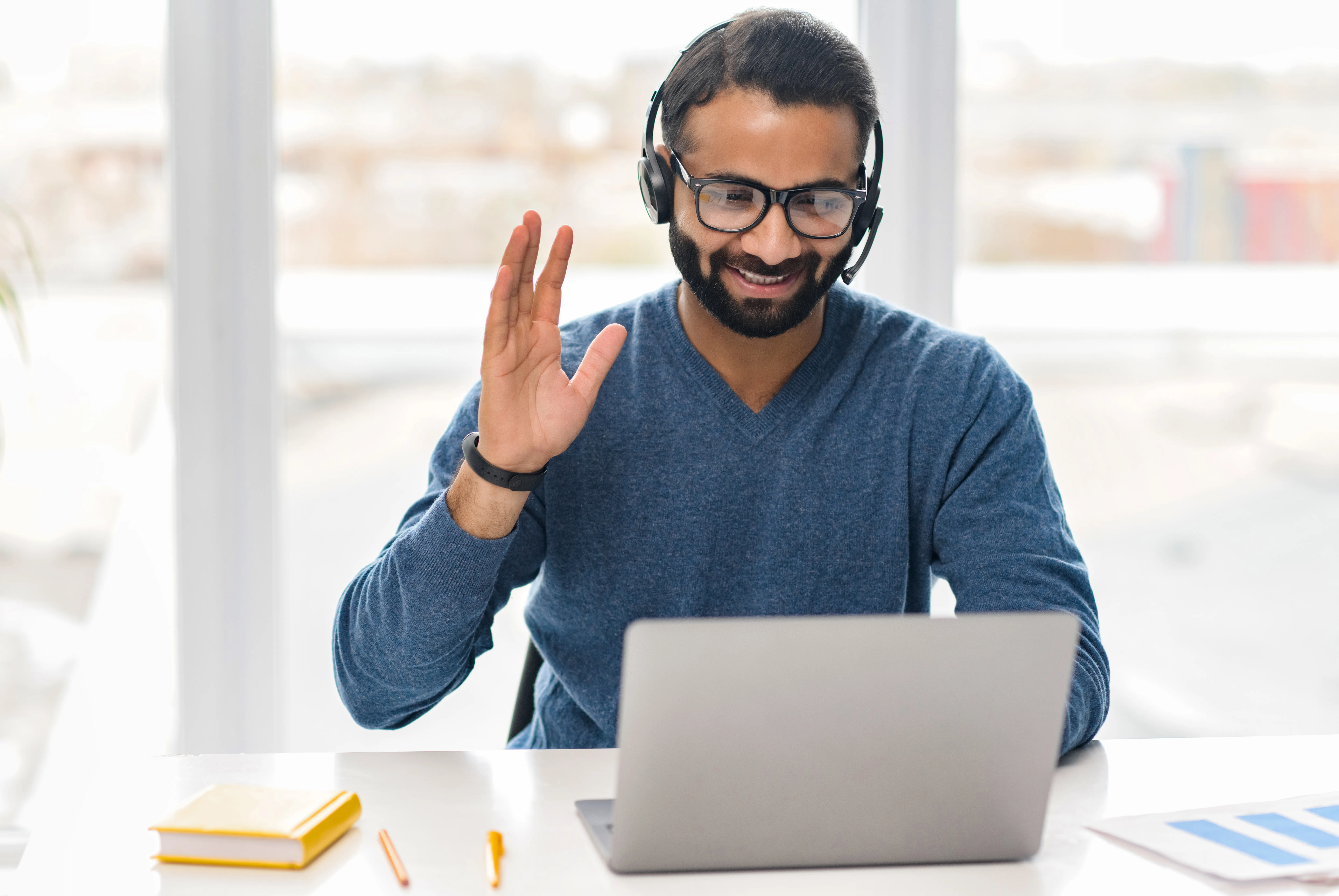 Indian man on virtual video call raising his hand