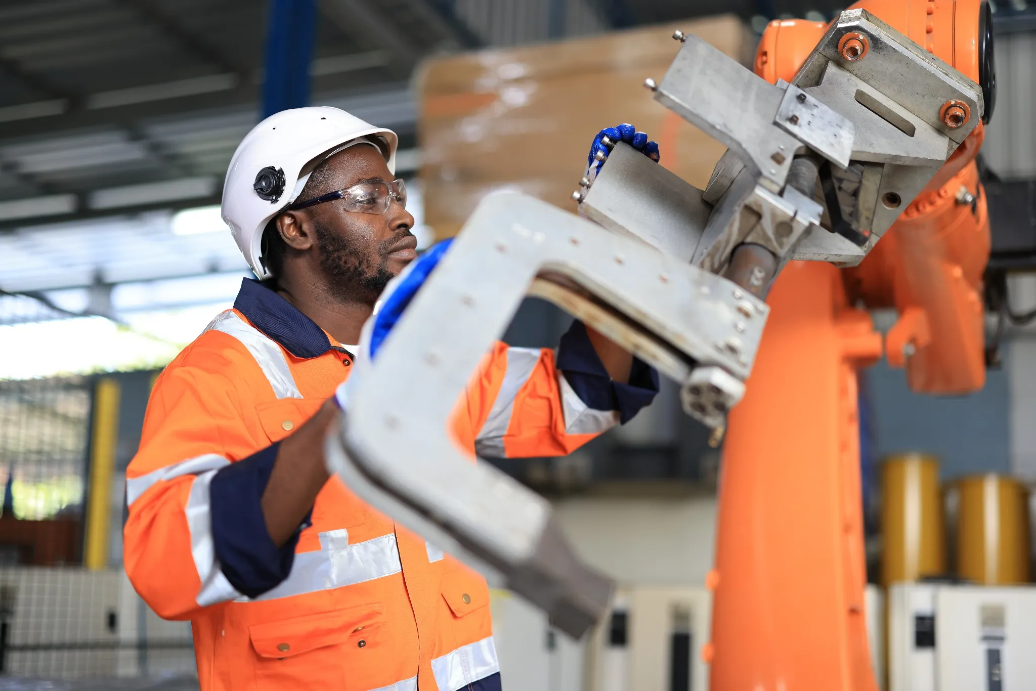 Development technician engineer testing artificial intelligence robot arm at high technology research manufacture with equipment.
