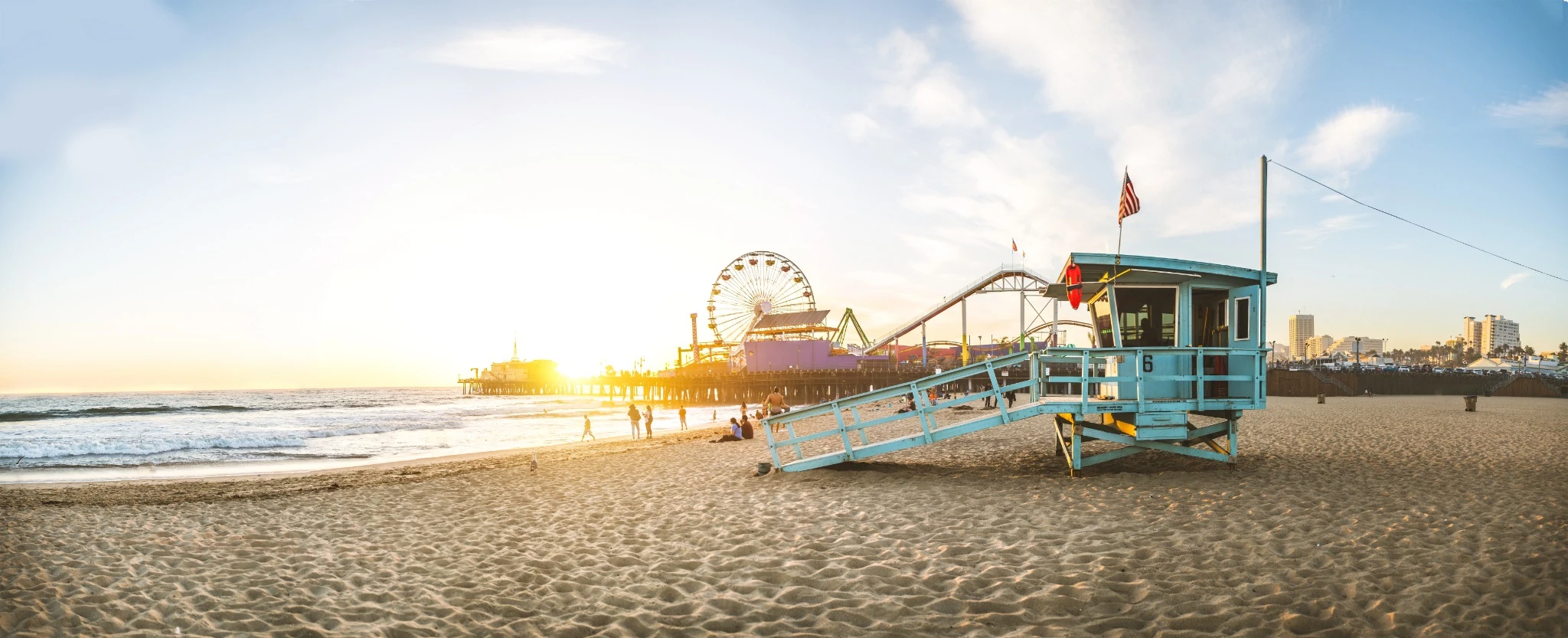 santa monica pier brightly lit at sunset