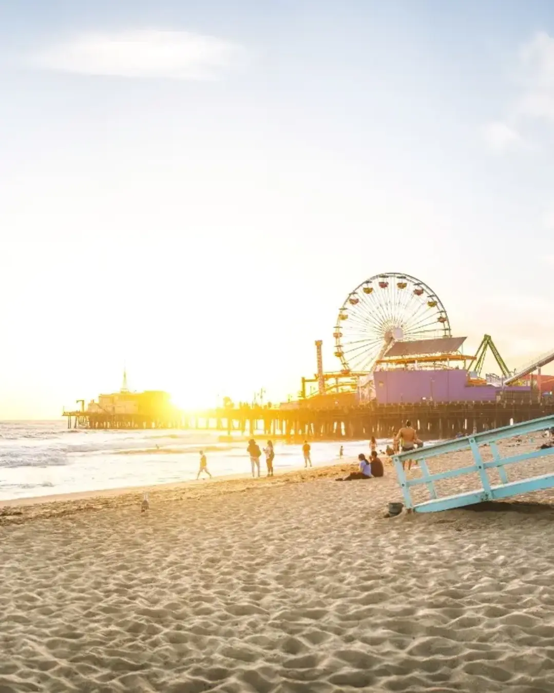 santa monica pier brightly lit at sunset