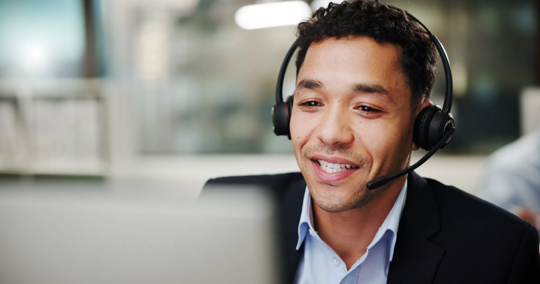 Man wearing headset talking to a customer