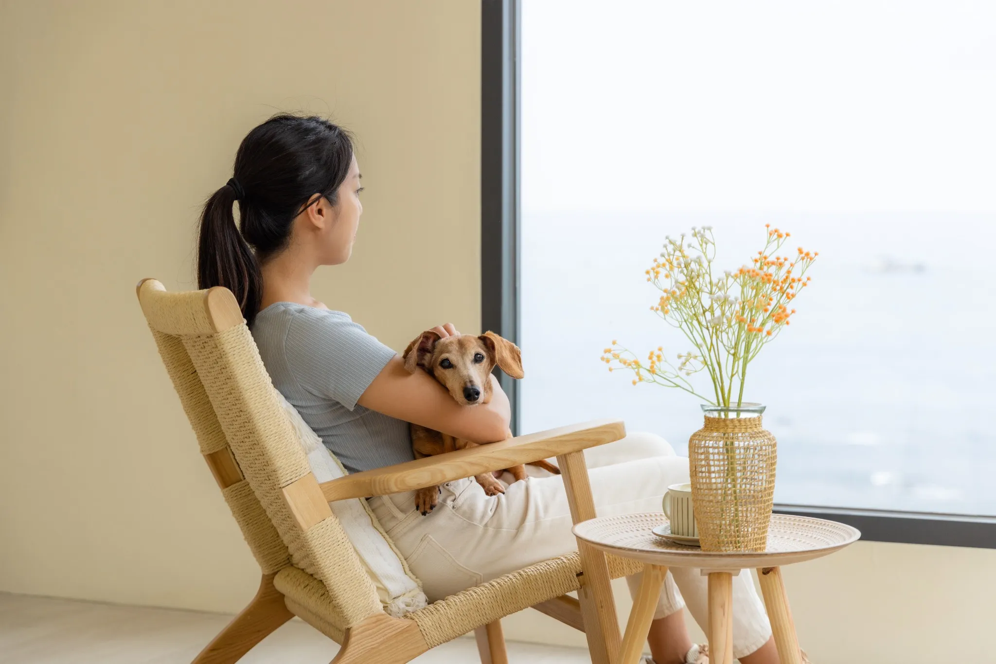 Woman holding her dog at home