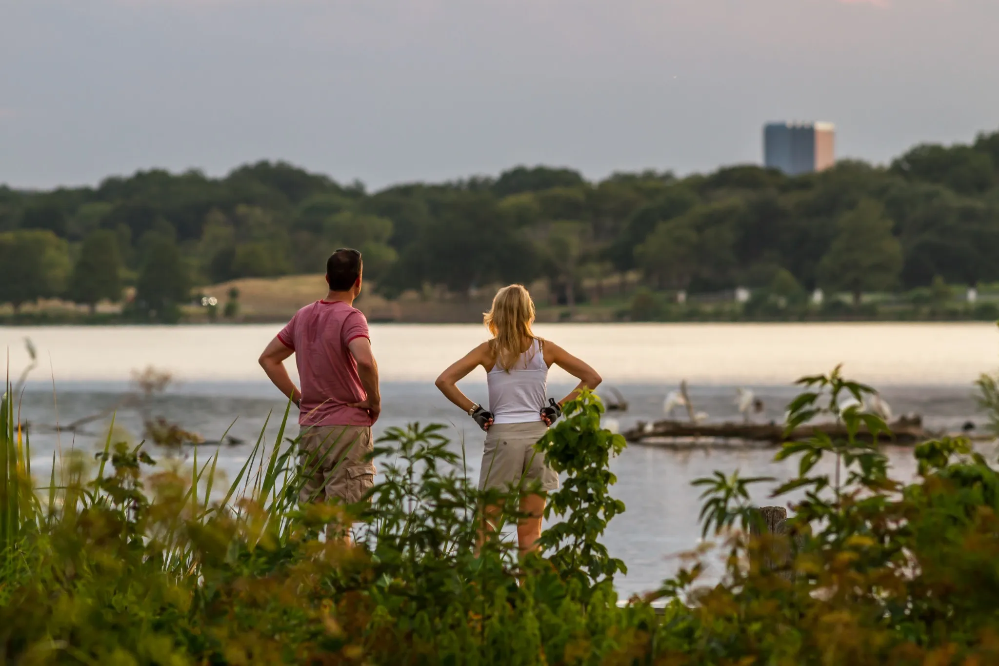Two people overlooking white rock lake in Dallas, TX