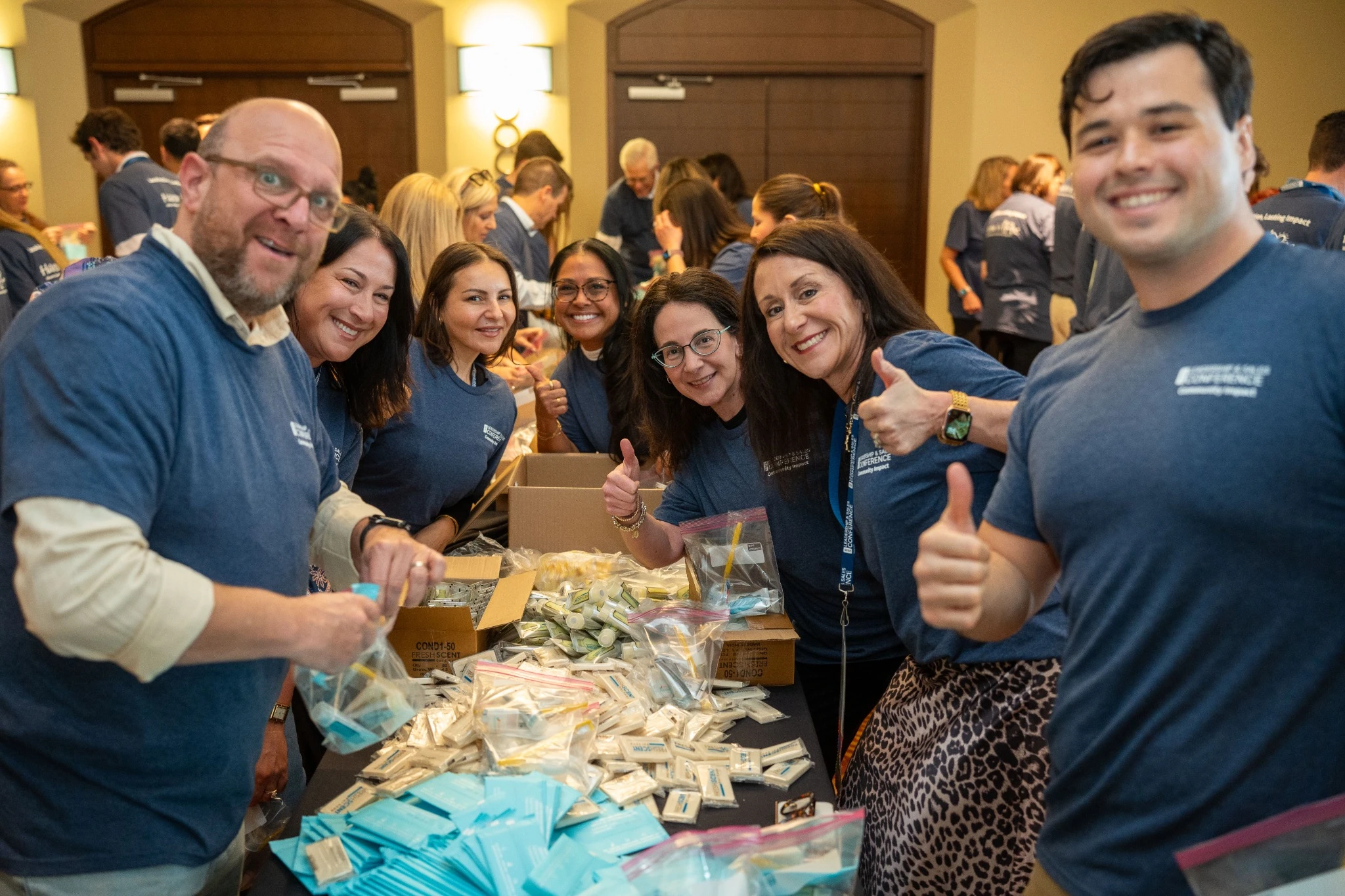 Group posed while assembling homeless kits for local community
