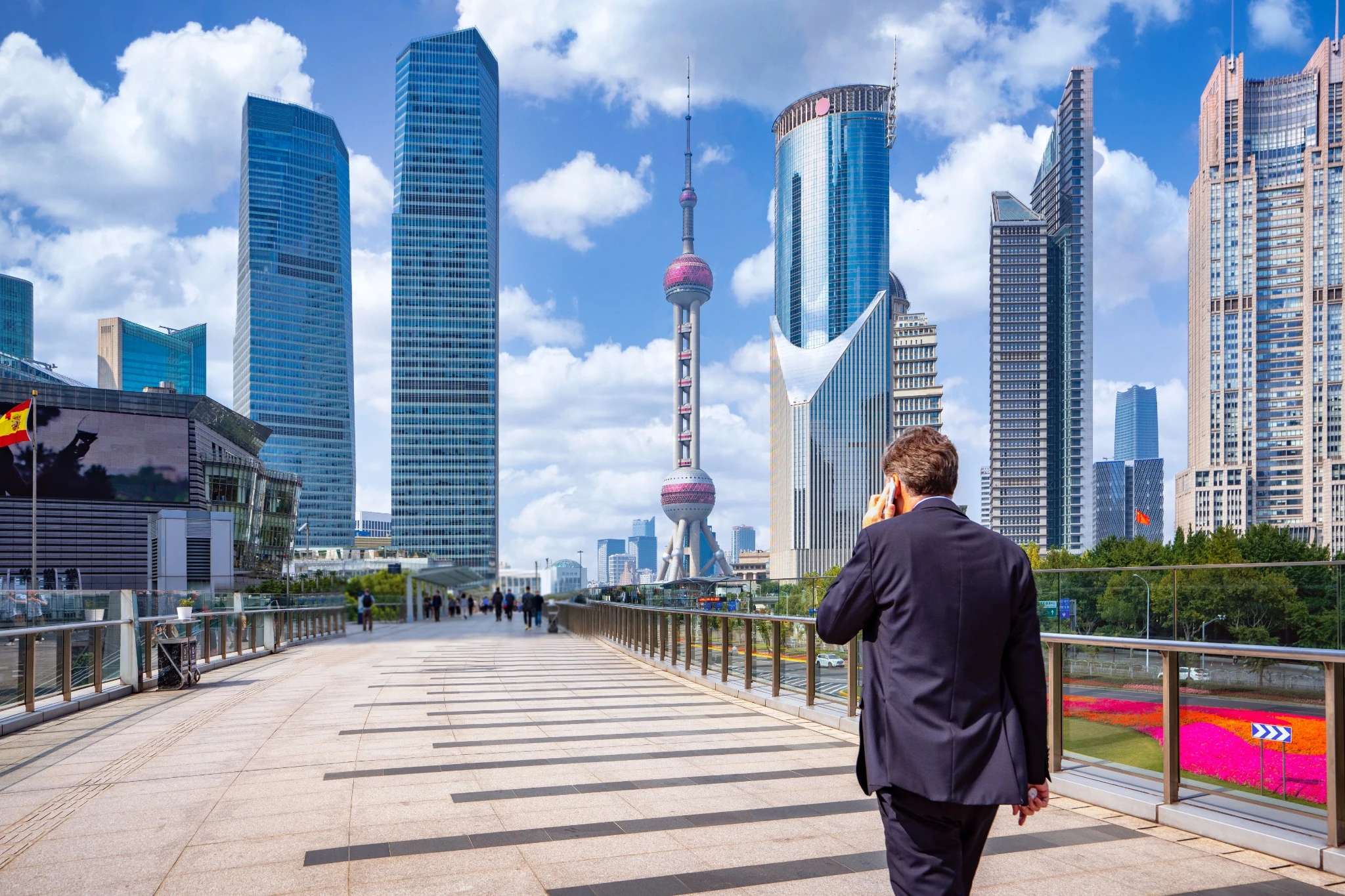 Business man walking and use smartphone in shanghai city.