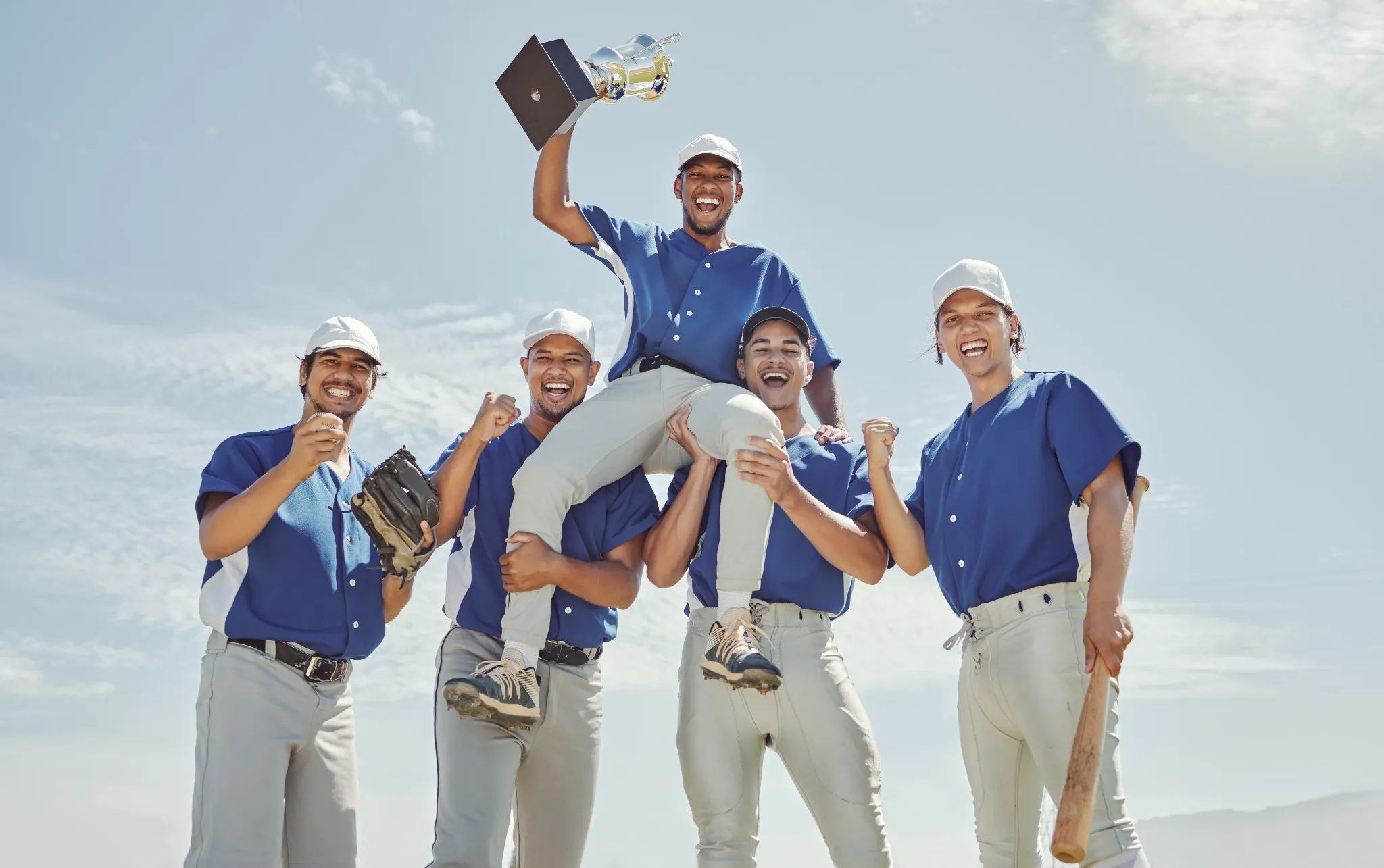Baseball team holding up trophy