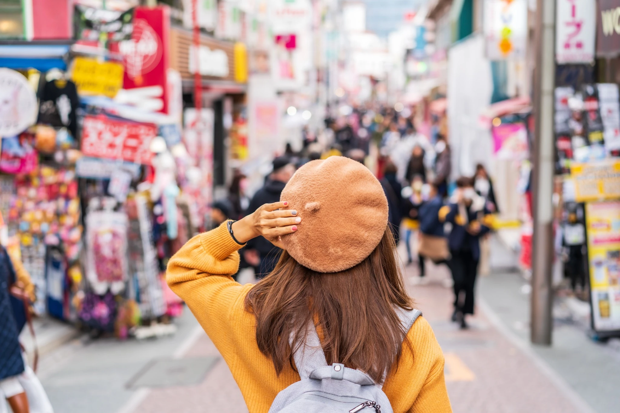 Young woman traveler walking on the Takeshita street in Harajuku the center of teenage fashion and cosplay culture in Tokyo.