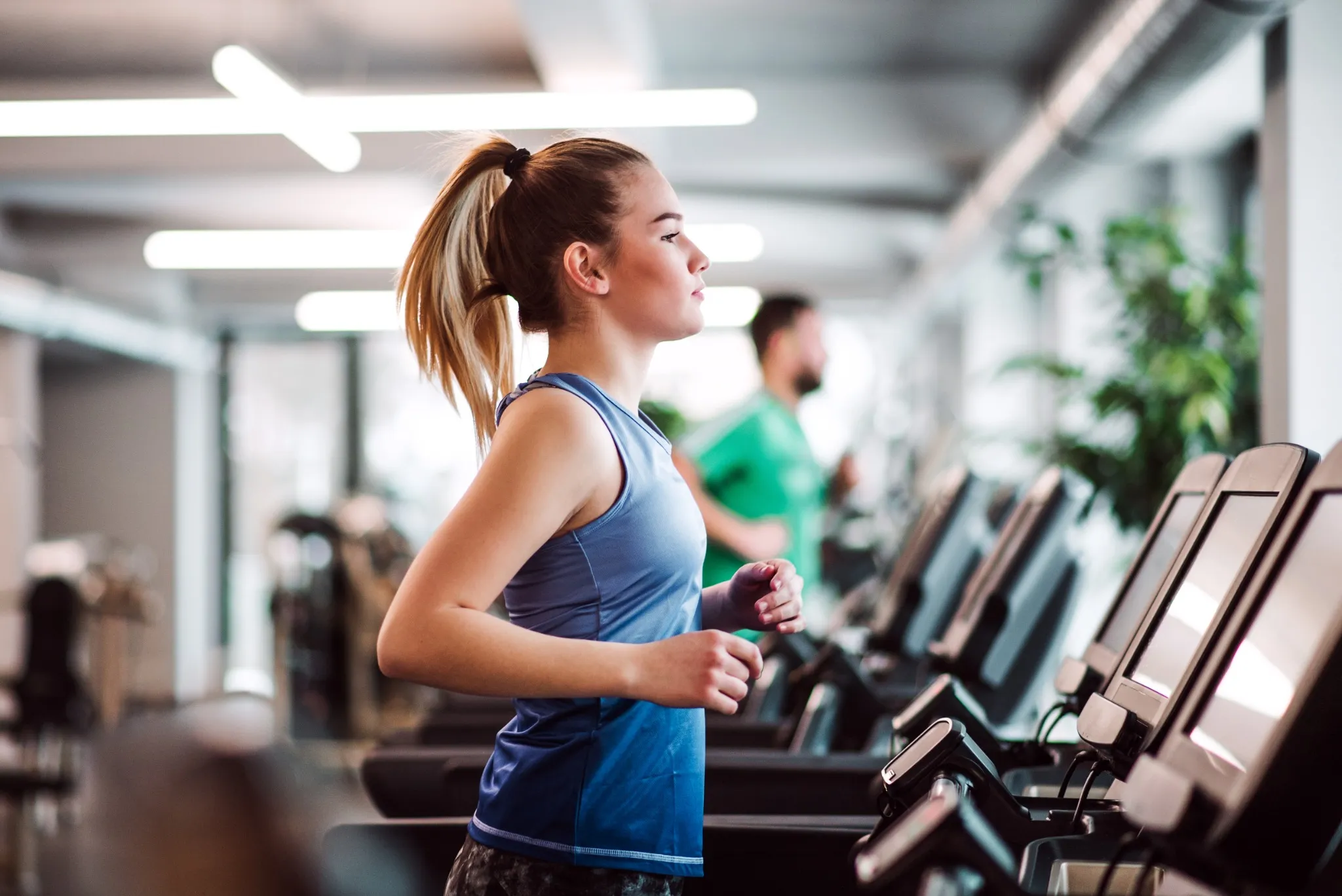 Girl running on treadmill in the gym