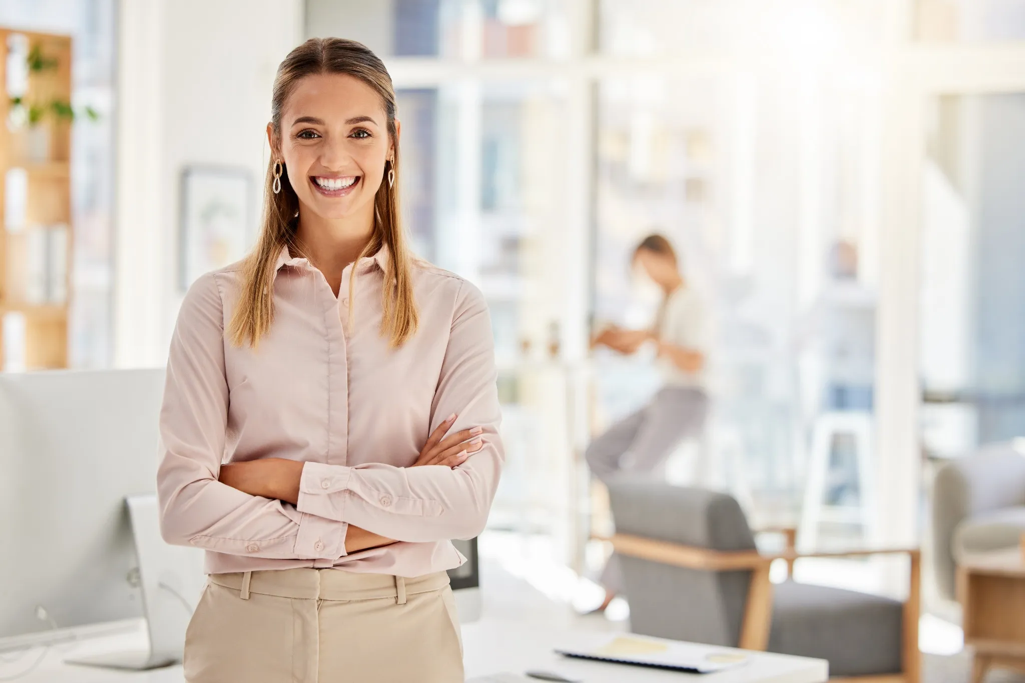 young woman smiling with arms crossed