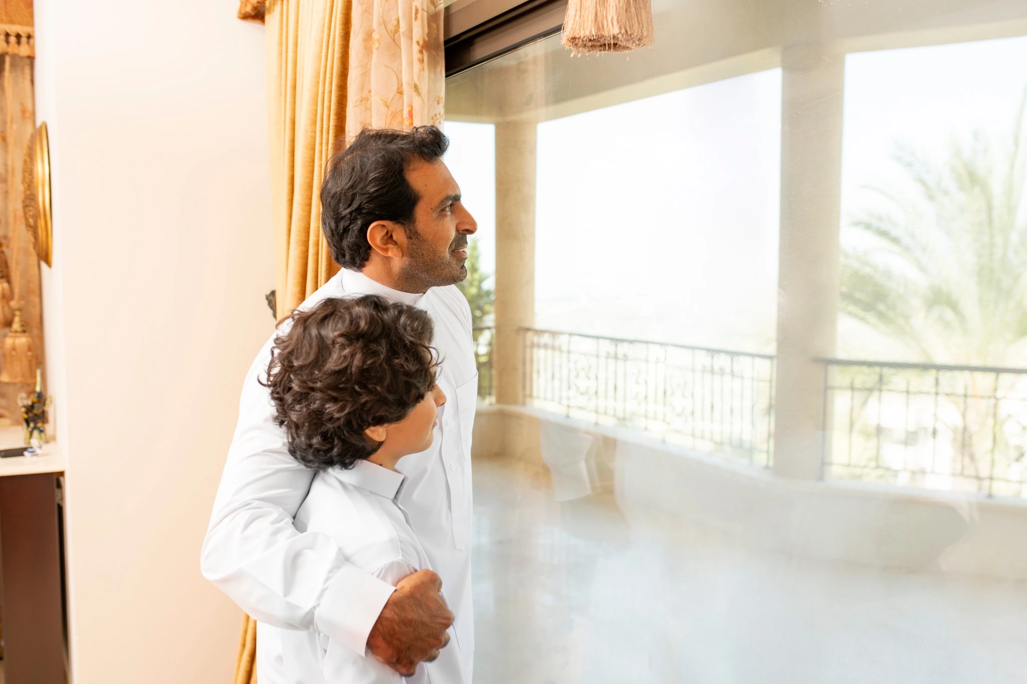 Arabian father and son having a talk at home.