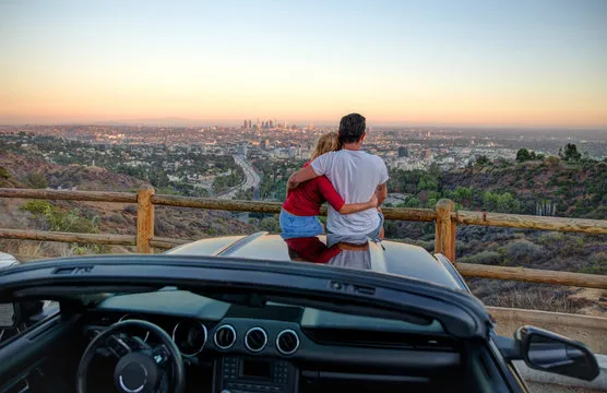 Couple watching sunset from popular view point in Los Angeles