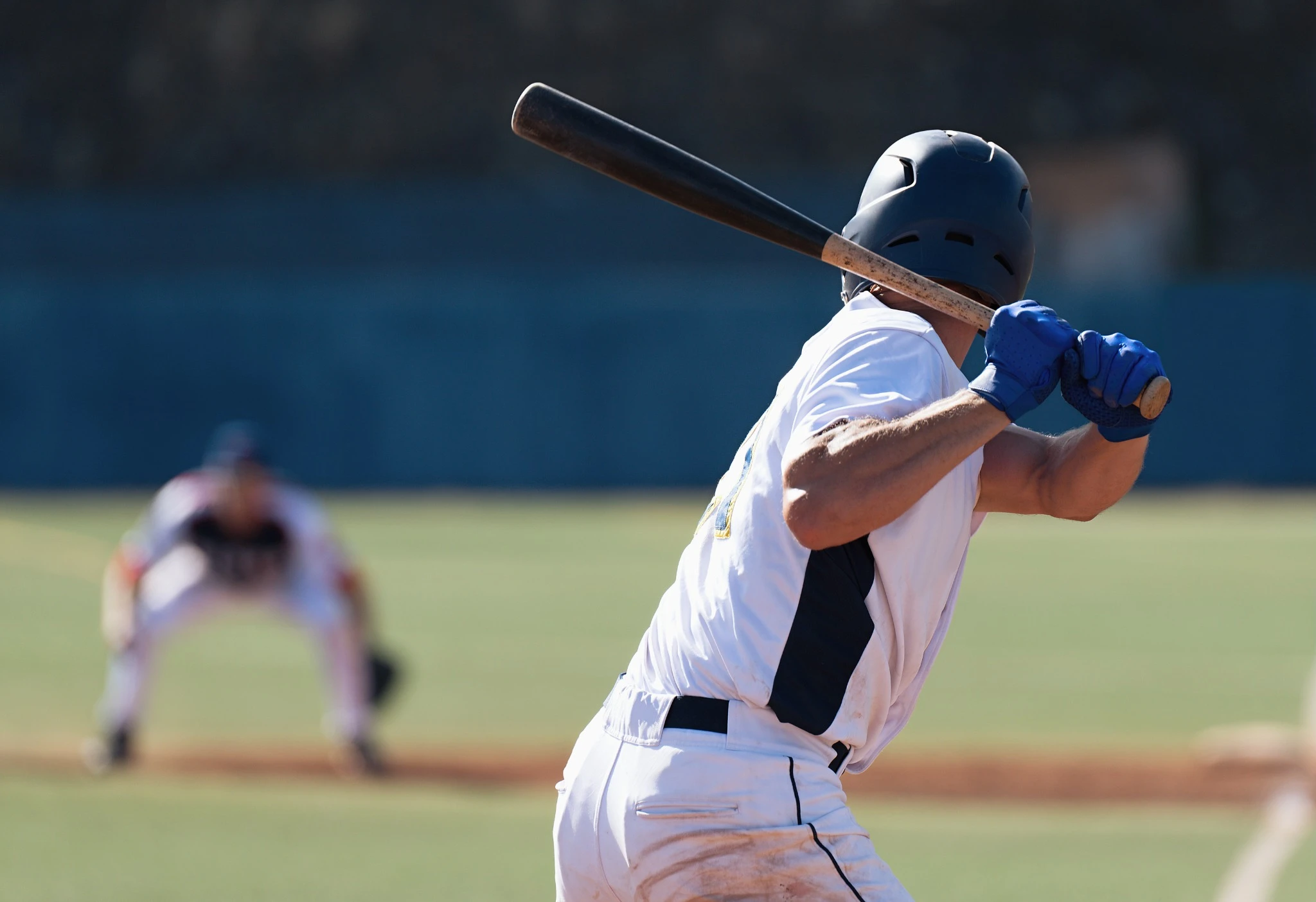 baseball player with bat back ready to swing