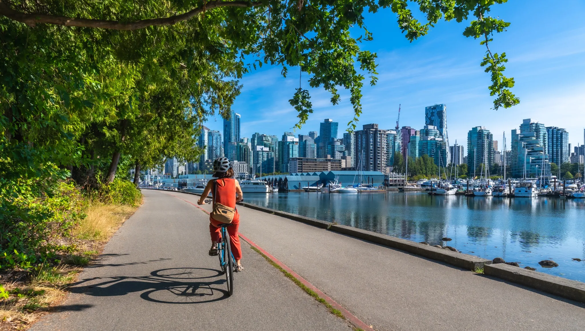Woman biking alongside water