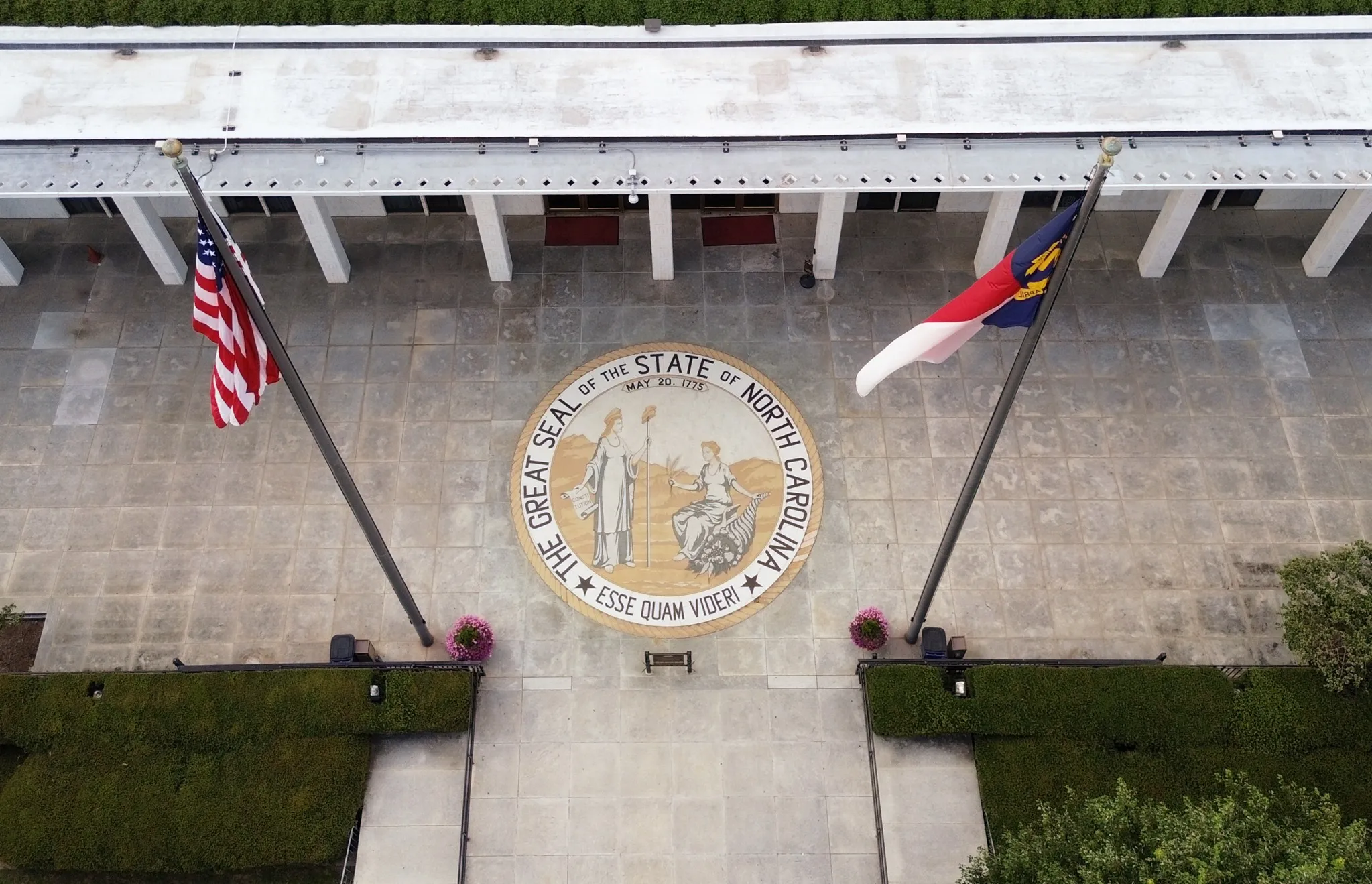 Aerial view of the North Carolina State legislature building with the state seal at the entrance.