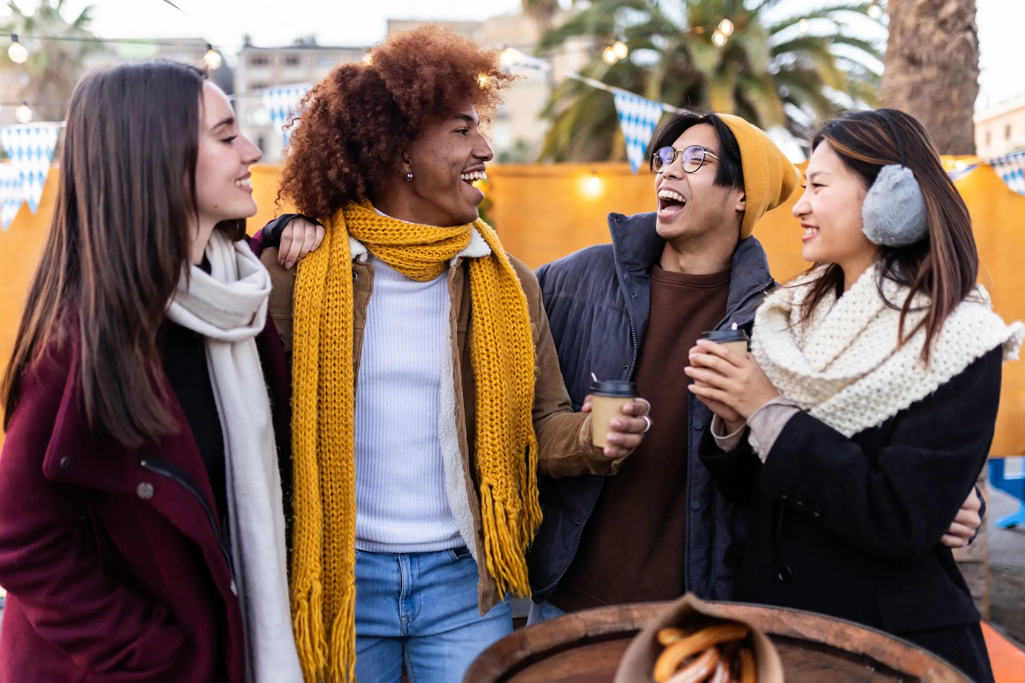 Diverse group of people having fun together at christmas market in winter.