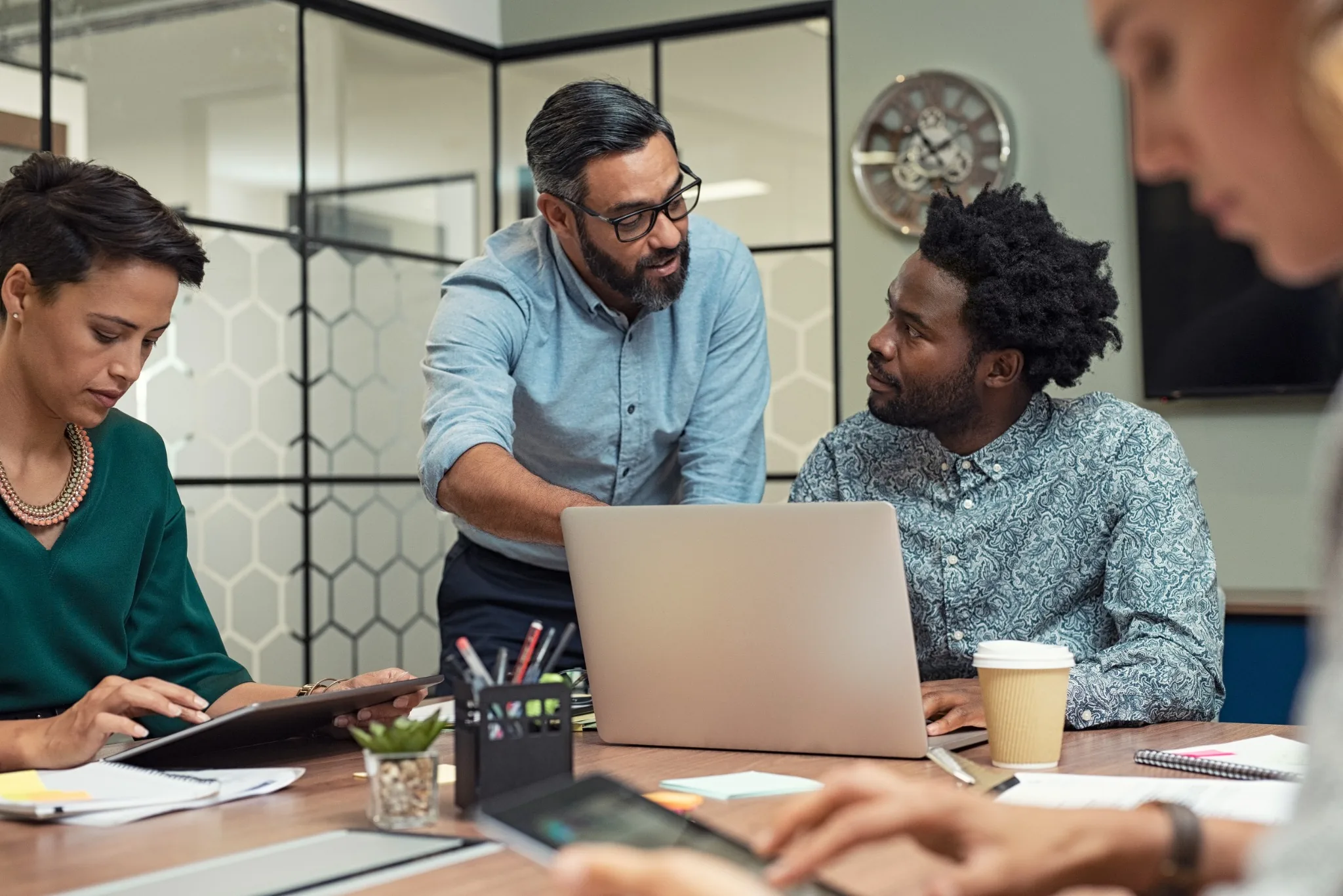 People working together on a laptop during a business meeting