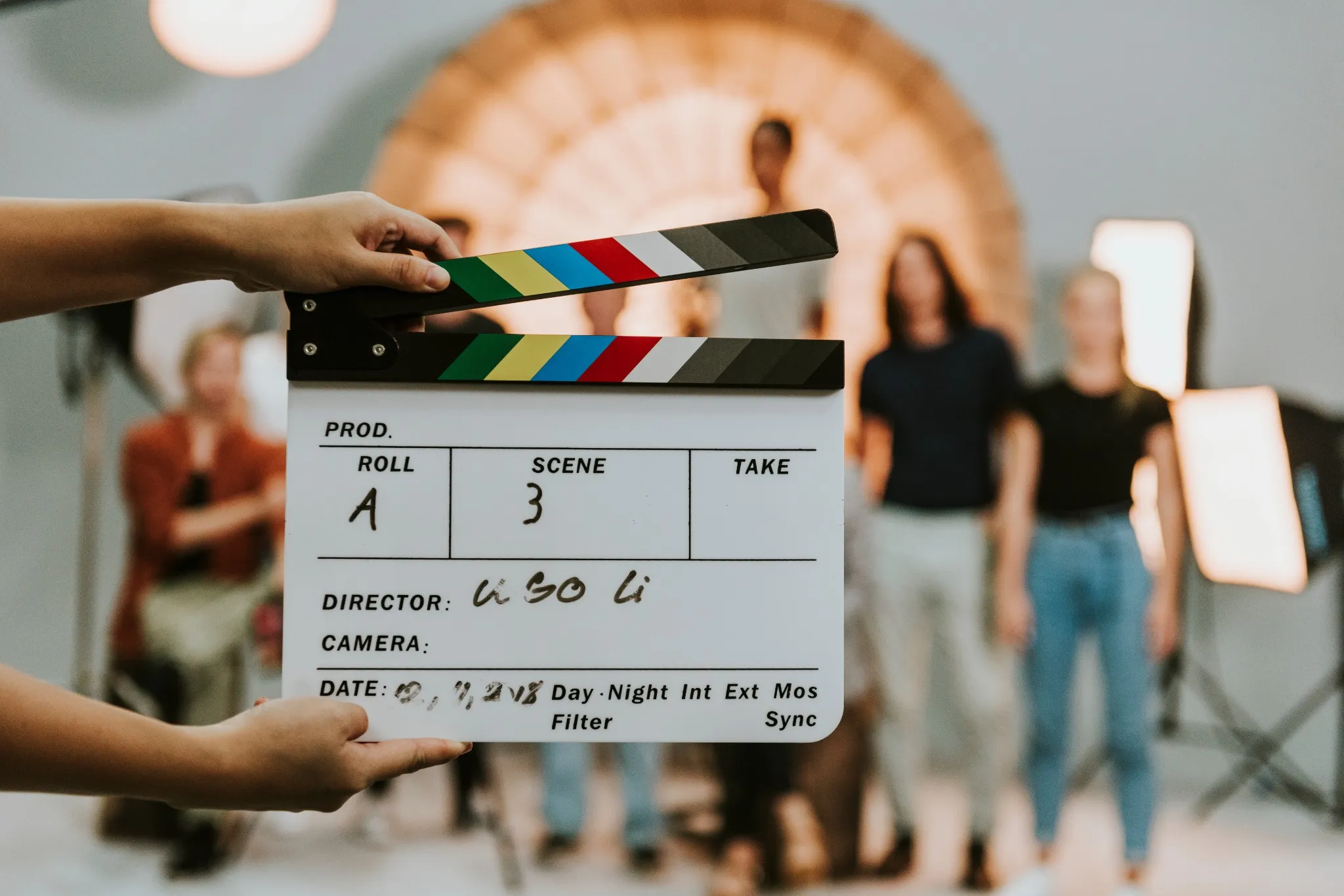 Woman holding a movie production clapperboard.