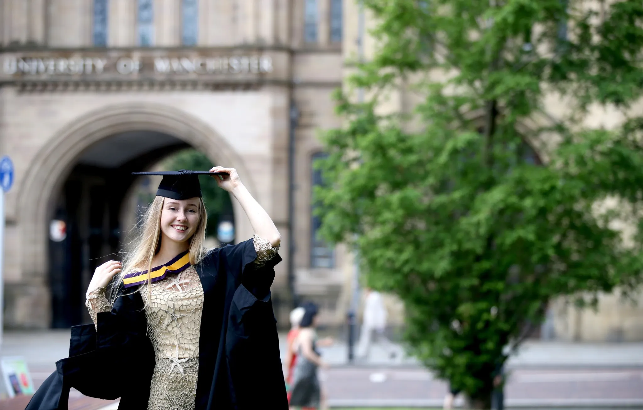 Portrait of a happy woman on her graduation day at university. Education and people.