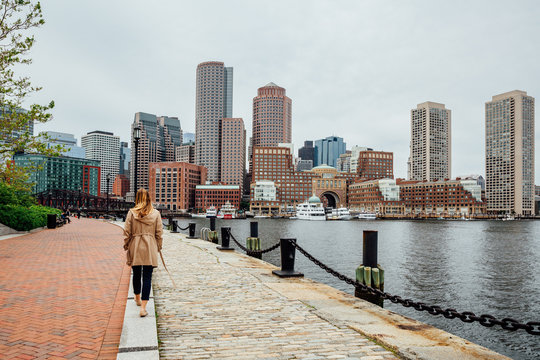 Woman in seaport walking along the harbor